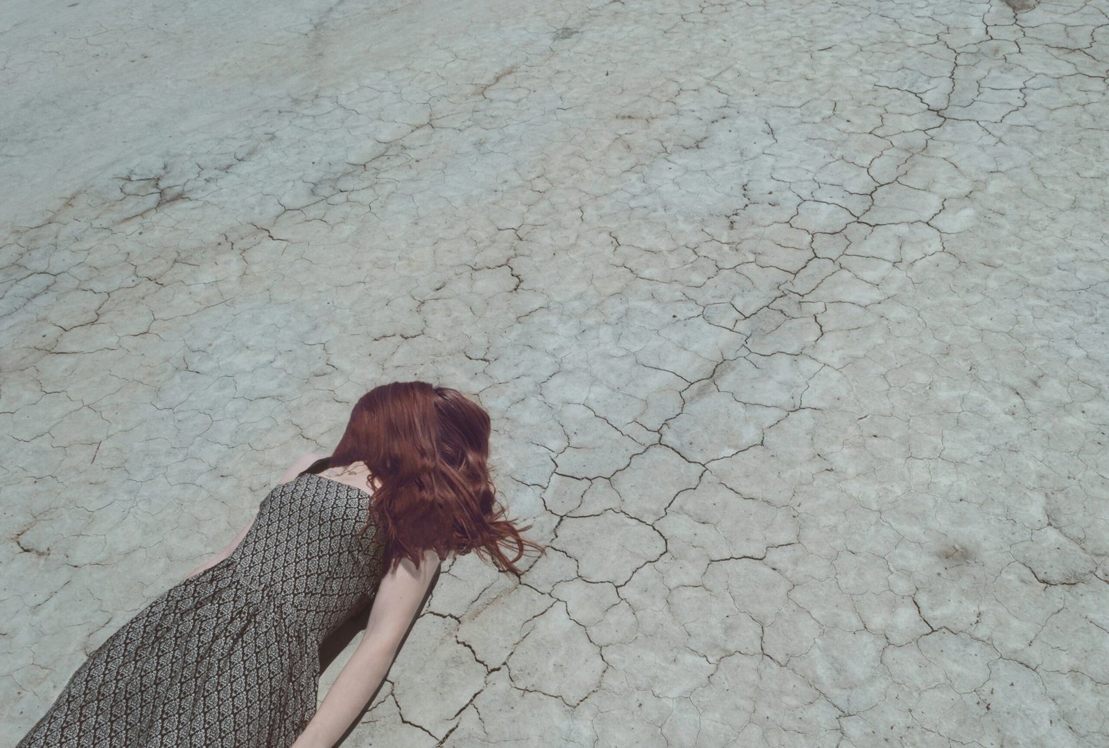girl feeling fatigued lying on the road